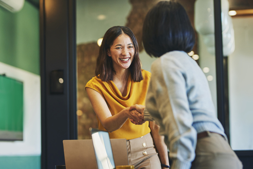 Woman shaking hands with experienced financial advisor