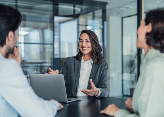 Financial advisor assisting couple on laptop